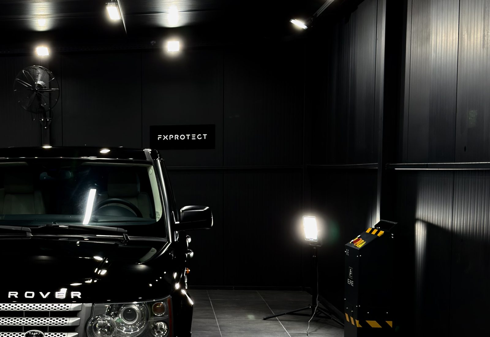 Controlled lighting rig set up around a vehicle at DSTNCT WERKS