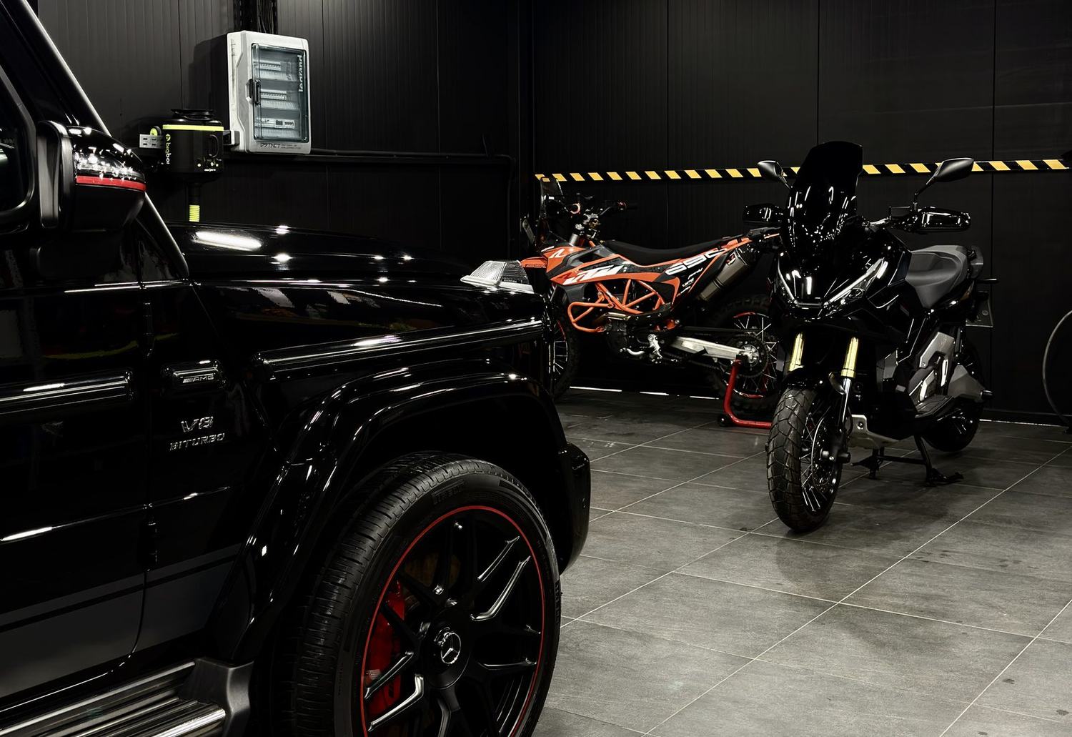 Cars and motorcycles together inside the DSTNCT WERKS studio in Mykonos